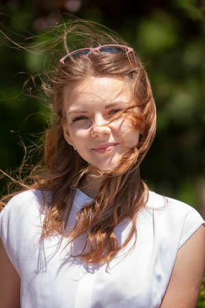 Woman smiling with perfect smile and white teeth in a park and looking at camera Portraitの写真素材
