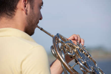 French horn instrument. Player hands playing horn music brass instrument Portraitの写真素材