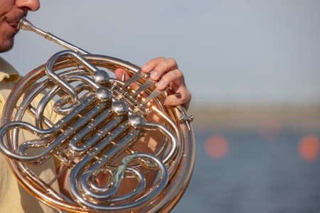 French horn instrument. Player hands playing horn music brass instrument Portraitの写真素材