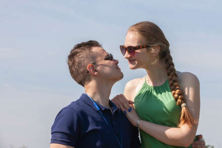 Portrait happy young smiling couple in love over flowering spring garden Close-up