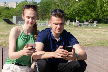 Portrait happy young smiling couple in love over flowering spring garden Close-upの写真素材