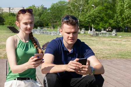 Portrait happy young smiling couple in love over flowering spring garden Close-upの写真素材
