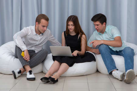 Educated advertisers, two guys and girl develop and place ads, conduct marketing research. Portrait