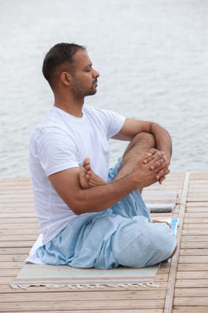 Man doing yoga exercise in the morning.. Portrait