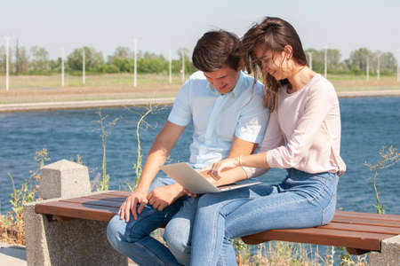 Cheerful young couple spending fun time at the park. Portrait.の写真素材