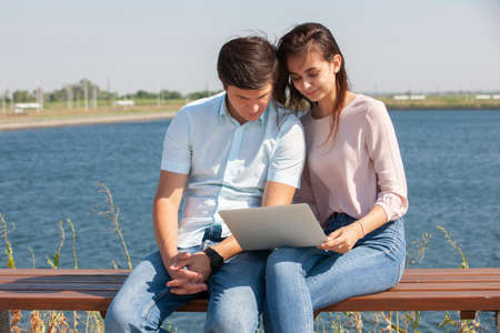 Cheerful young couple spending fun time at the park. Portrait.の写真素材