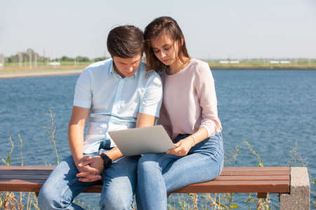 Cheerful young couple spending fun time at the park. Portrait.の写真素材