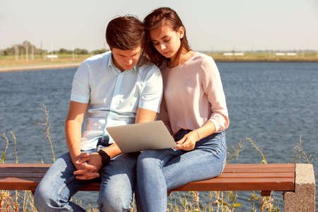 Cheerful young couple spending fun time at the park. Portrait.の写真素材