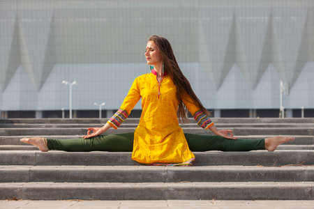 Pretty woman doing yoga exercises in the park. Portrait.の写真素材