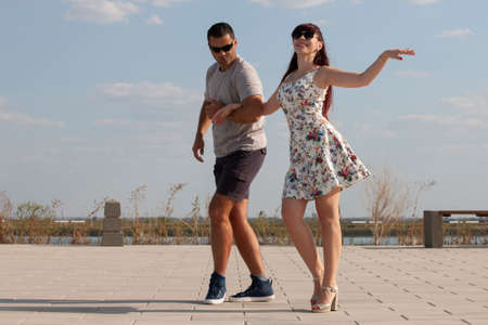 Passionate elegant young couple latino dancers in tango in the park, romantic and sporty lifestyle....