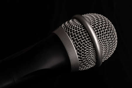 Close-up black microphone head isolated on black background. Image can be used as background. There is a place for text.の写真素材
