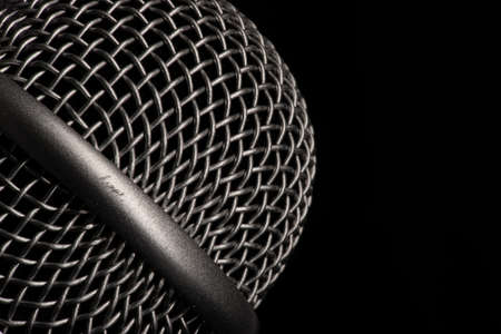 Close-up black microphone head isolated on black background. Image can be used as background. There is a place for text.の写真素材