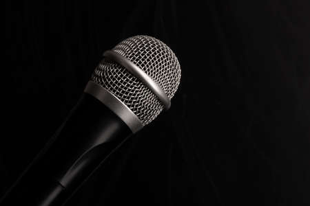 Close-up black microphone head isolated on black background. Image can be used as background. There is a place for text.の写真素材
