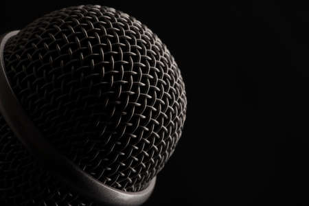 Close up head audio microphone in black background with copy space on the right. Macro shot.の写真素材