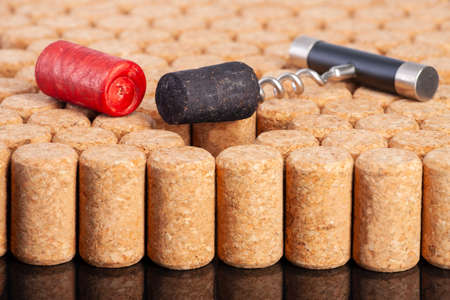 Many identical corks for wine. Red and black corks stand out. The concept of tolerance, the fight against racism and homobobia. Close-up.の写真素材