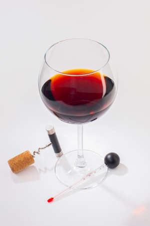Glass of red wine on a white background and with soft shadow. Close-upの写真素材