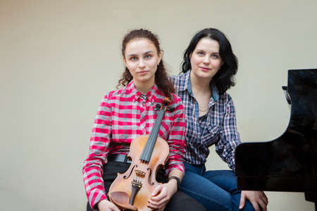 Musicians of the symphony orchestra. Young violinist and pianist. Portrait.の写真素材