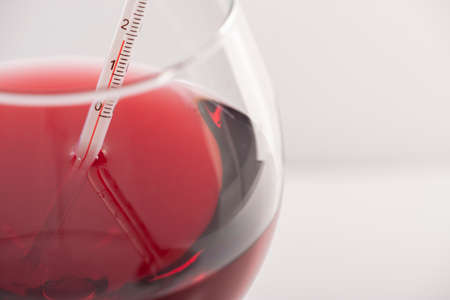 Measuring Red Wine Temperature with a Wine Thermometer. Close-up