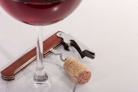 High angle view with shallow depth of field of a glass of red wine with a sommelier tools. Close-up.の写真素材