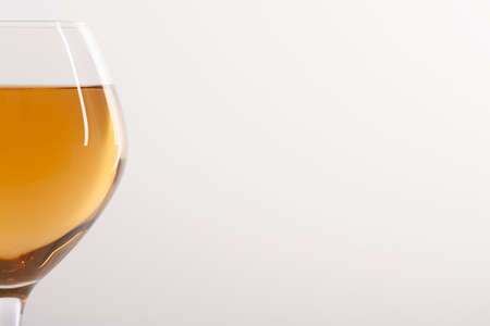 Glass of white wine on a white background and with soft shadow. There is a place for text. Close-upの写真素材