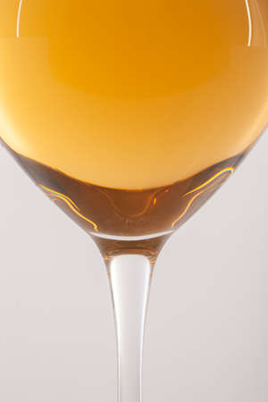 Glass of white wine on a white background and with soft shadow. There is a place for text. Close-upの写真素材