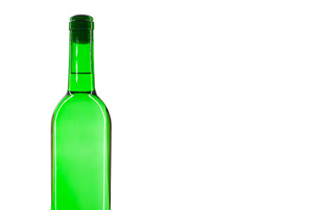 Green bottle with a white sparkling wine, isolated on white background. There is a place for text. Close-up.の写真素材
