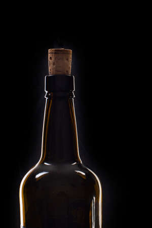 Closeup of an opening of a wine bottle with cork in front of black background with text field. Macro.の写真素材
