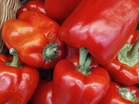 Orange, green and yellow sweet mix bell peppers close up bulgarian pepper fresh, assorted colorful capsicum paprika on a counter in the supermarket.の写真素材