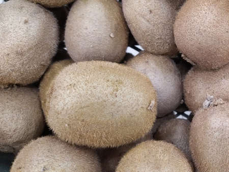 Kiwi fruits on the counter for sale in a vegetable shop. Close-upの写真素材