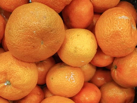 Bunch of fresh tangerines oranges on market. Close-upの写真素材