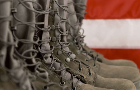 Sage green military combat boots with US flag in the background.の写真素材