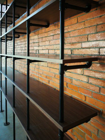 Wooden shelve and brick wall in the interior of a modern buildingの写真素材
