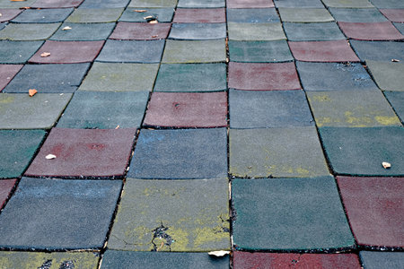 Colorful old rubber floor tiles in the playgroundの写真素材