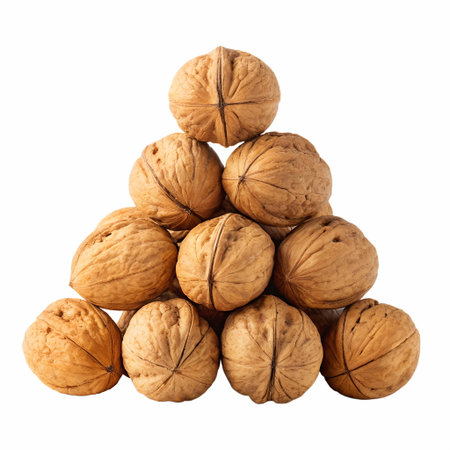 Creative arrangement of walnuts stacked in a pyramid shape, isolated on transparent backgroundの素材