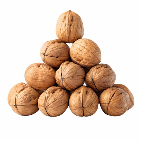 Creative arrangement of walnuts stacked in a pyramid shape, isolated on transparent backgroundの素材