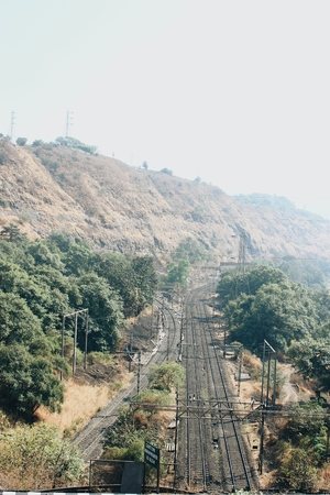 Railway tracks surrounded by mountains.