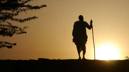 GWALIOR, INDIA - APRIL 12, 2016: An unidentified indian old man standing in evening time. Silhouette shot.のeditorial素材