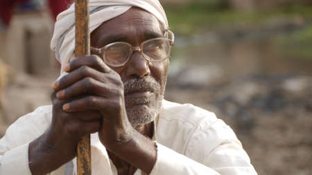 GWALIOR, INDIA - APRIL 16, 2016: An unidentified indian old man sitting and thinking.のeditorial素材