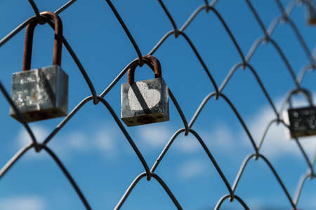 old rusty lock on fence,love locked.の写真素材