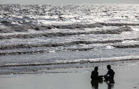 silhouette of kids playing on the beach