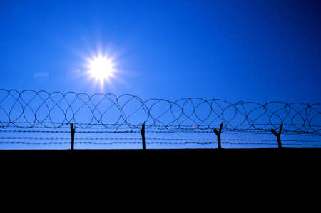 Fence with a barbed wire の写真素材