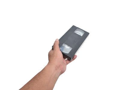VHS cassette in hand isolated on white の写真素材
