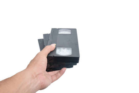 VHS cassette in hand isolated on white の写真素材