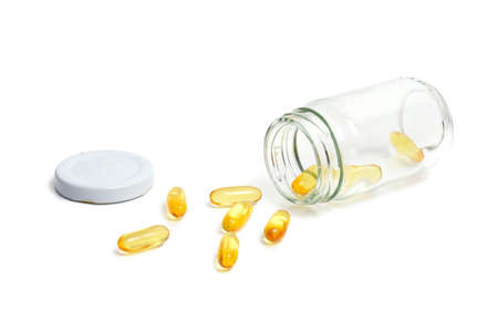 medicine bottle and pills over white background