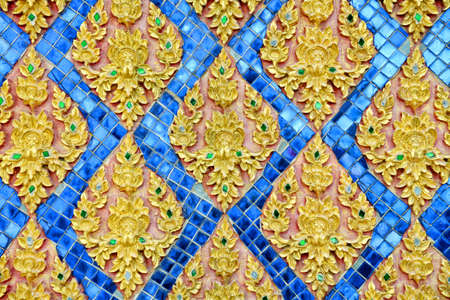 Thai stucco pattern style on wall with golden painted color 