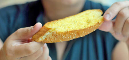 Hand hold Garlic Bread