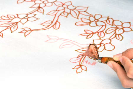 Batik painting on a white cloth process close up. thailandの写真素材