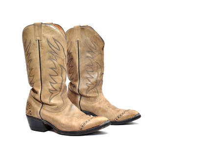 Cowboy's boots from a natural leather on a white background