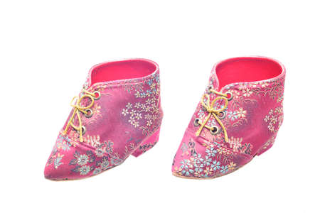 Miniature antique chinese woman's shoes worn by an old woman with bound feetの写真素材