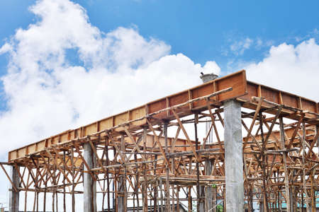 Construction site with scaffolding against blue clear skyの写真素材